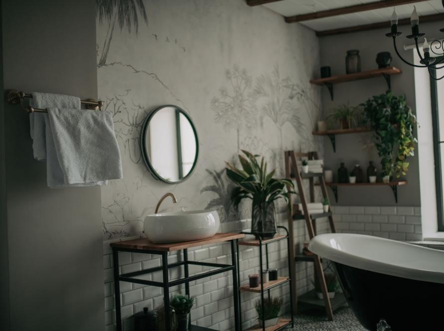 Eco-style modern bathroom interior featuring an oval freestanding bathtub, minimalist accessories, and soft natural lighting