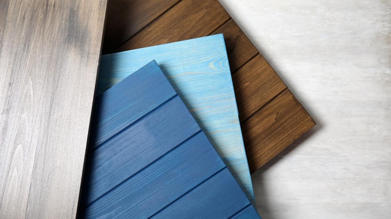 Multiple wooden siding materials displayed with varied grain textures for home exterior cladding