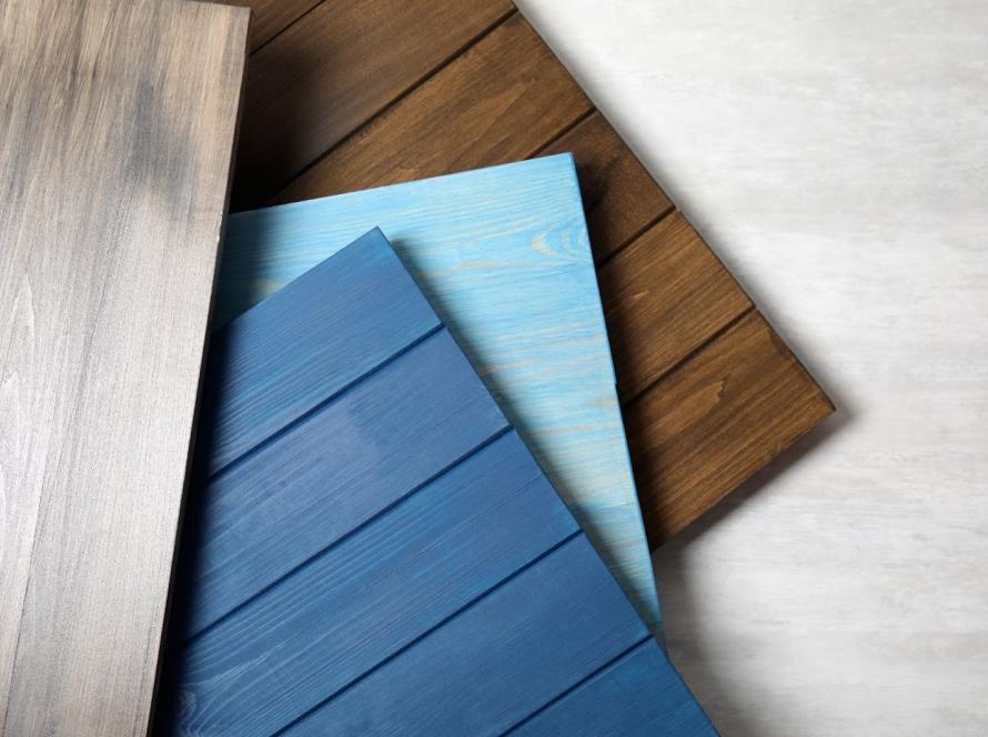 Multiple wooden siding materials displayed with varied grain textures for home exterior cladding